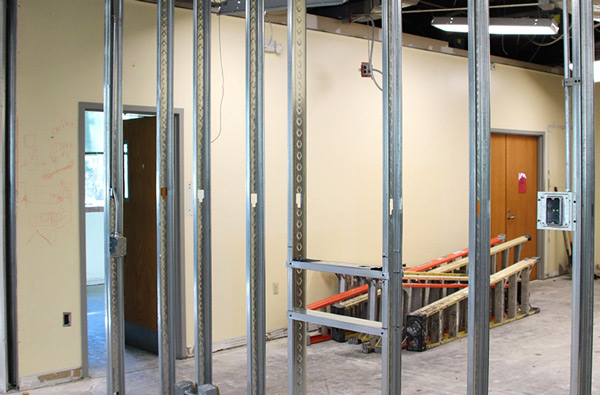 Open construction area with support beams and ladders